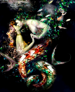aquatic couple embracing underwater